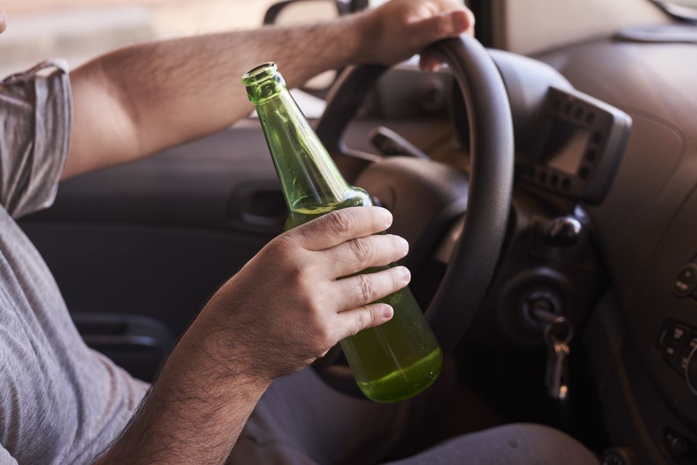 bottle beer man s hands driving car daytime