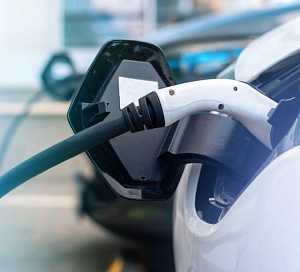 plugged chargers into two electric cars charge station